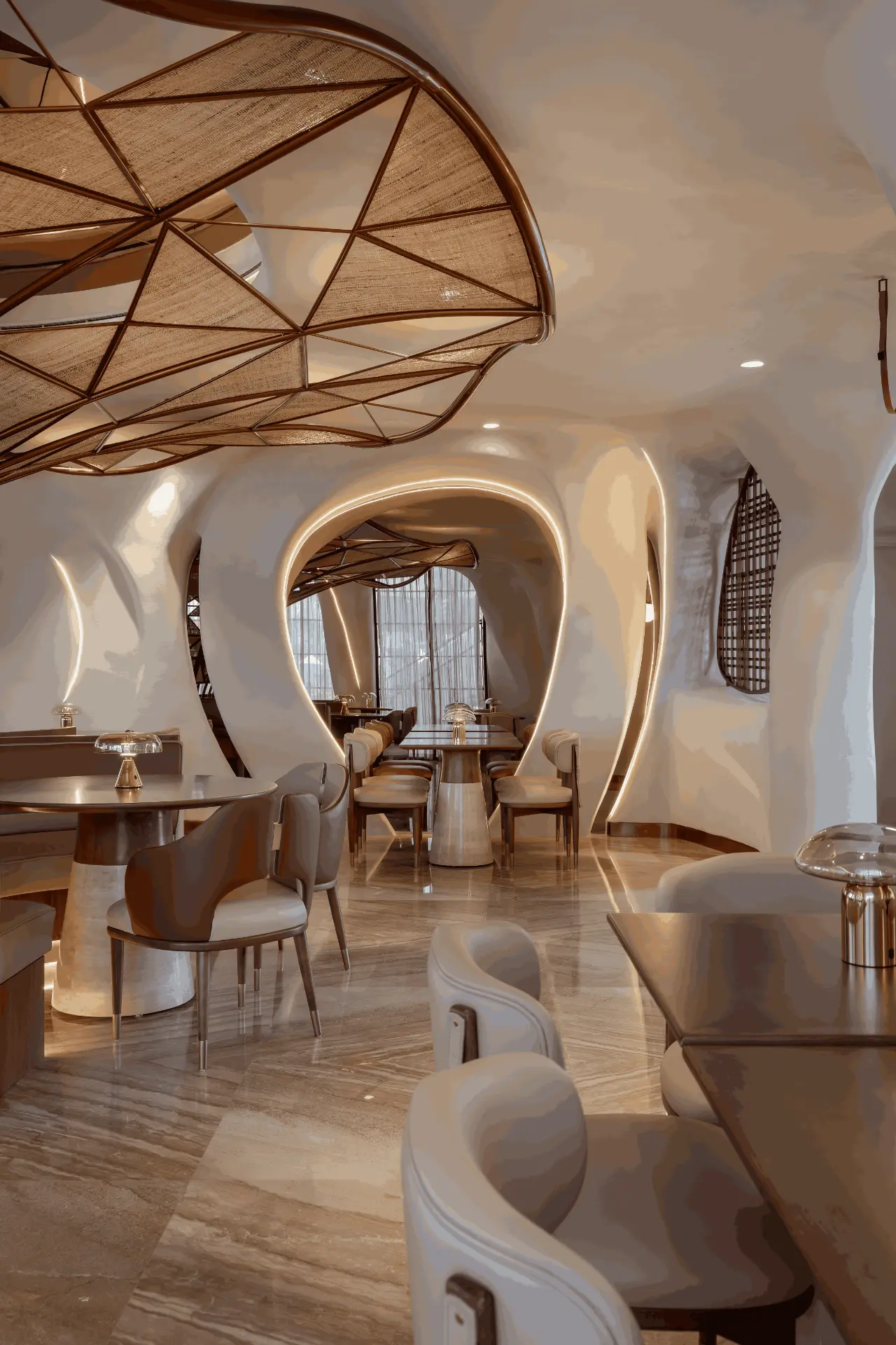 Falwa dining room with organic walls beneath the woven canopy